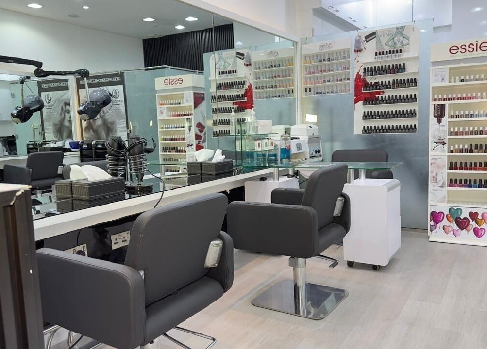 Modern interior of Lya Arabi Beauty Salon in Dubai, AE with nail polish displays and styling chairs.