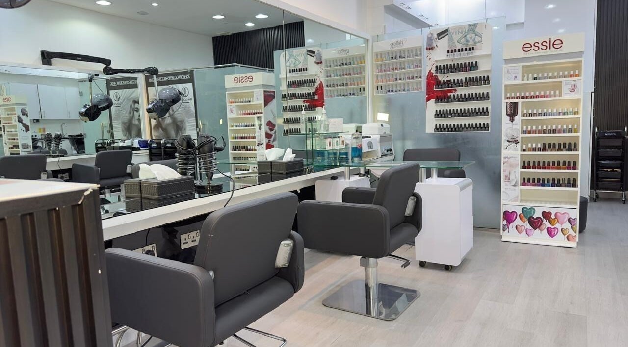 Modern interior of Lya Arabi Beauty Salon in Dubai, AE with nail polish displays and styling chairs.
