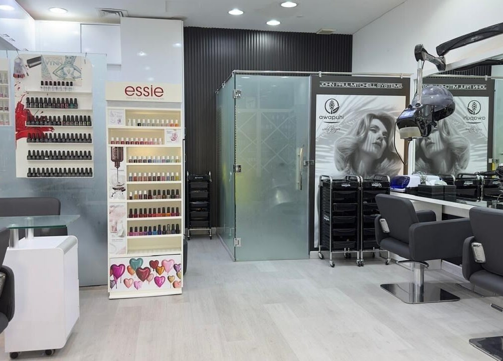 Modern salon interior at Lya Arabi Beauty Salon, Dubai, AE featuring sleek chairs and nail polish displays.