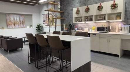 Elegant waiting area at Outlaw Shears, Spring, Texas, US with modern seating and wall decor.