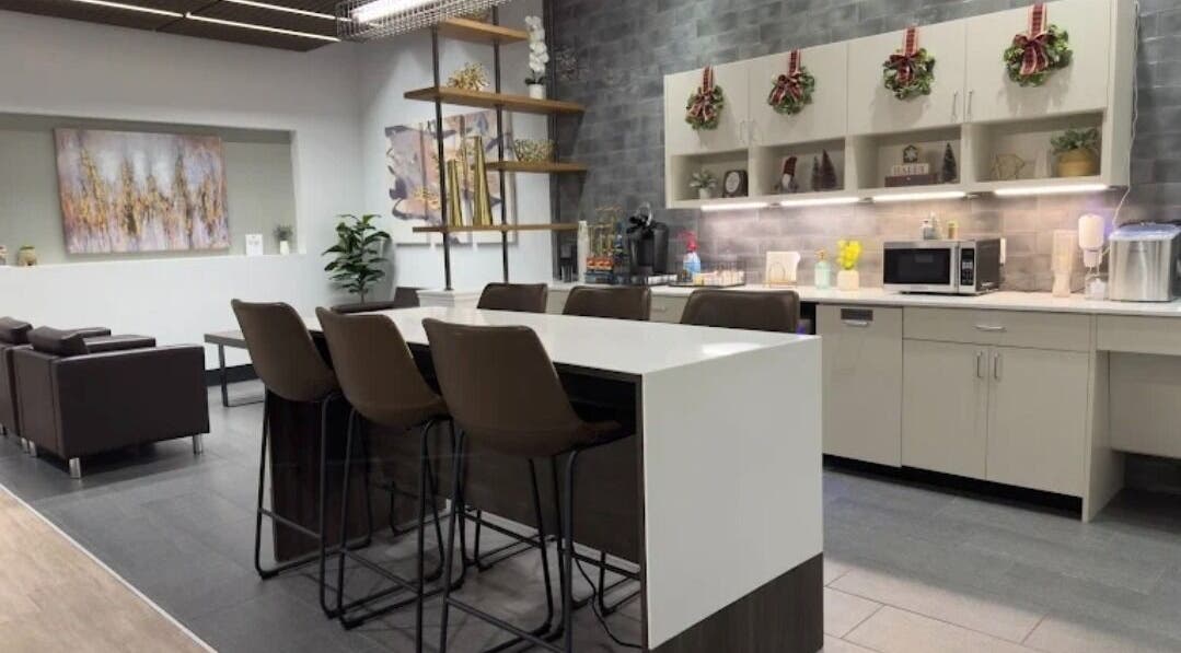 Elegant waiting area at Outlaw Shears, Spring, Texas, US with modern seating and wall decor.