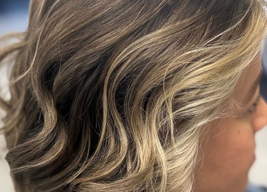 Stylish blonde waves hairstyle at Hair Design From Ashley, Glen Burnie, Maryland, US.