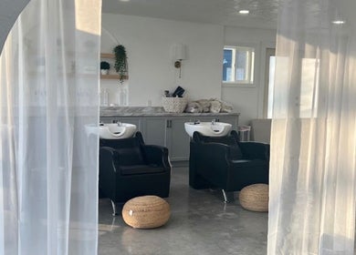 Spacious salon interior at hairwith.maddz, Nephi, Utah, US, featuring elegant wash stations and soft lighting.