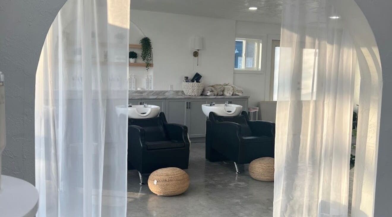 Spacious salon interior at hairwith.maddz, Nephi, Utah, US, featuring elegant wash stations and soft lighting.