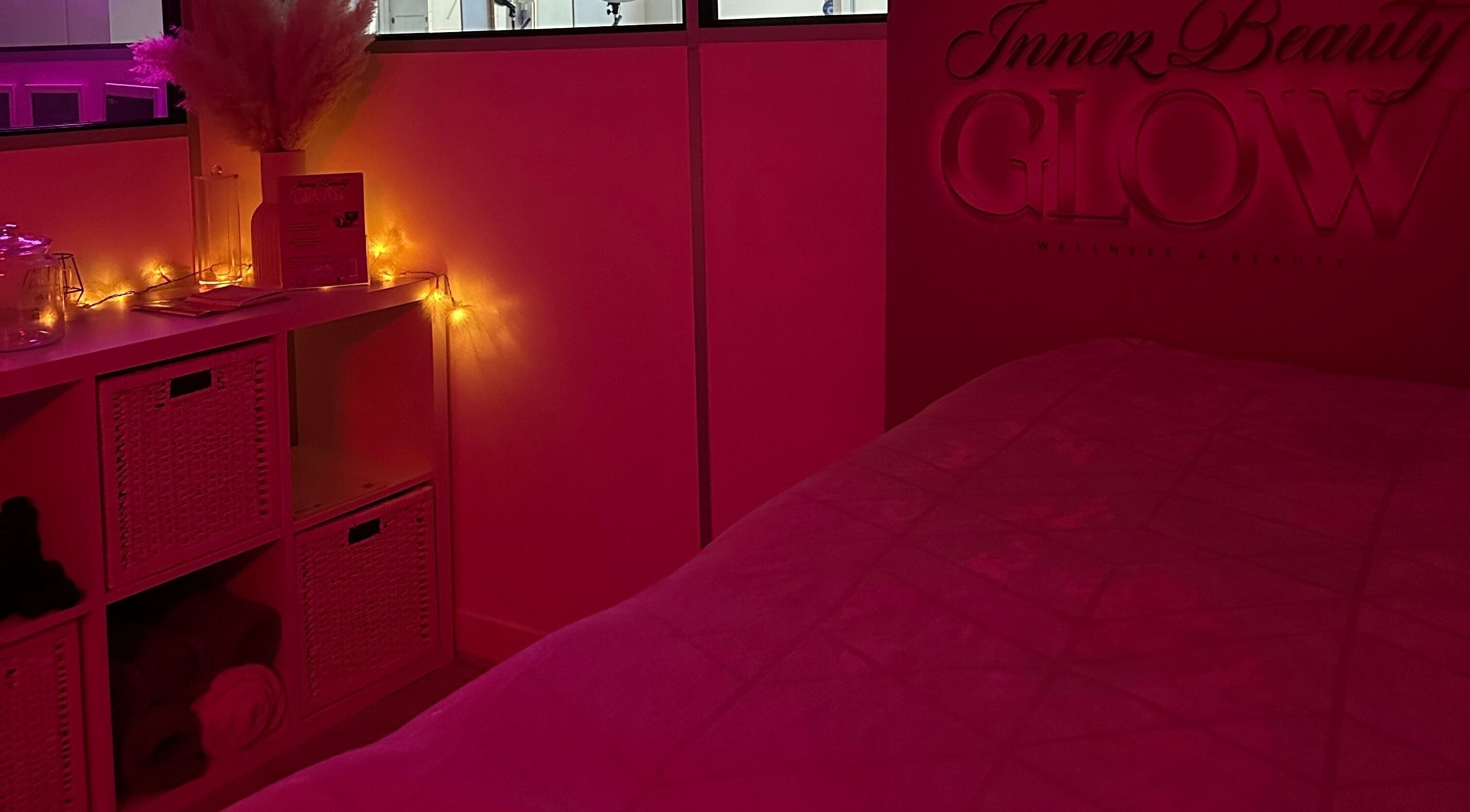 Cozy, warmly-lit treatment room at Inner Beauty Glow, London, England, GB with ambient lighting and decor.