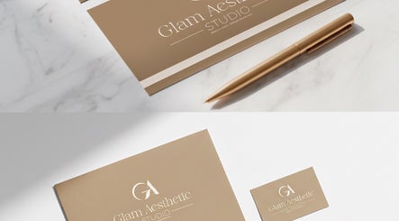 Glam Aesthetic Studio business cards and pen on marble surface, London, England, GB.