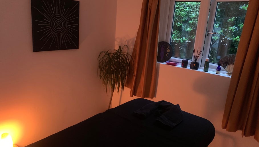 Peaceful massage room at Holistic With Holly, Selling, England, GB, with soft lighting and calming decor.