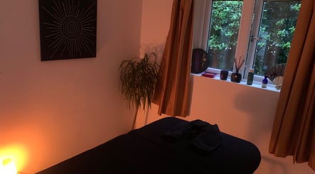 Peaceful massage room at Holistic With Holly, Selling, England, GB, with soft lighting and calming decor.