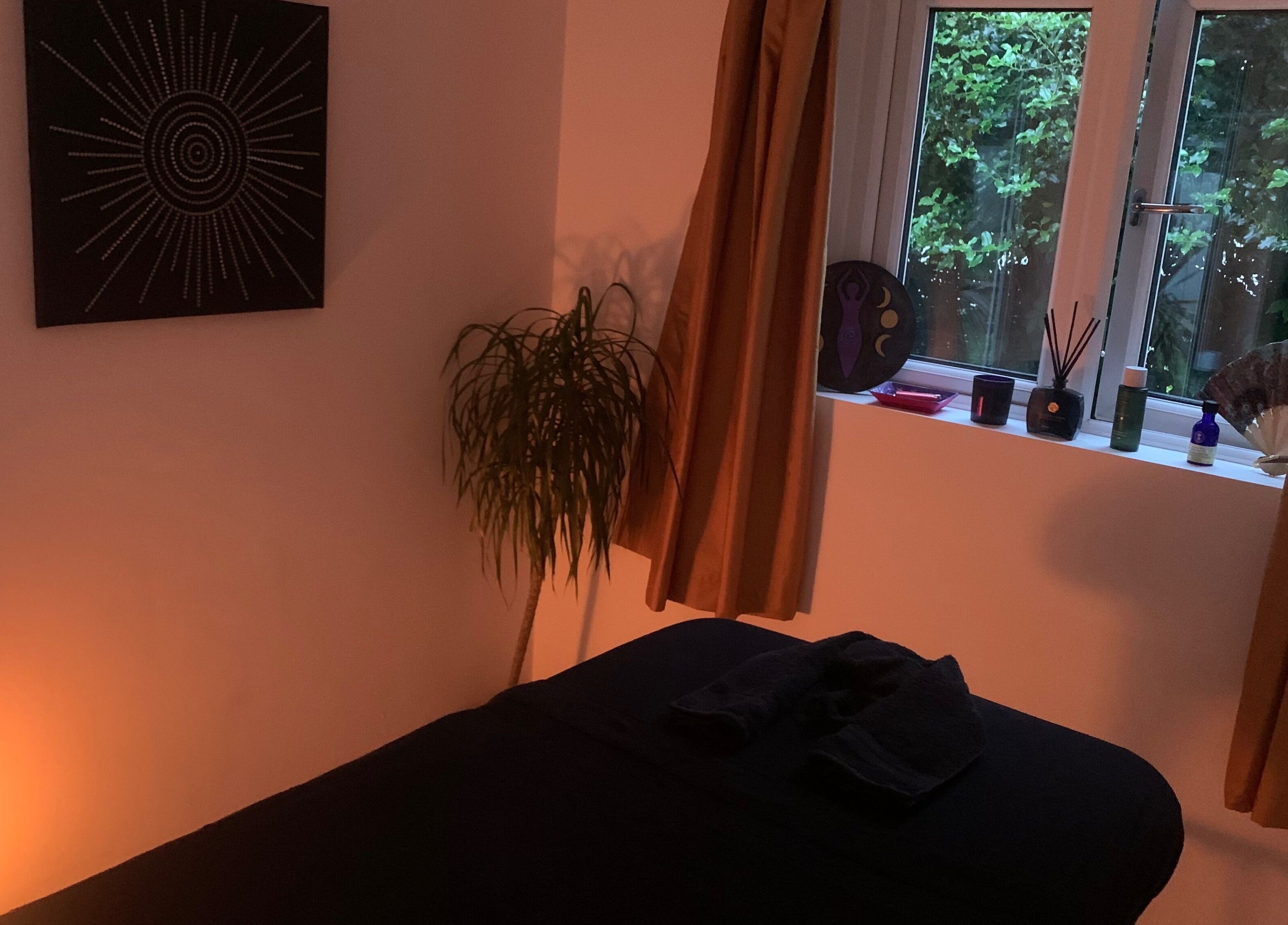 Relaxing massage room at Kaph Massage Therapies, Selling, England, GB, with soft lighting and calming decor.