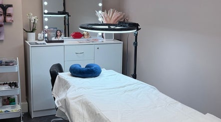 Cozy treatment room at London Skin Therapy, Hounslow, England, GB, featuring a massage table and serene decor.