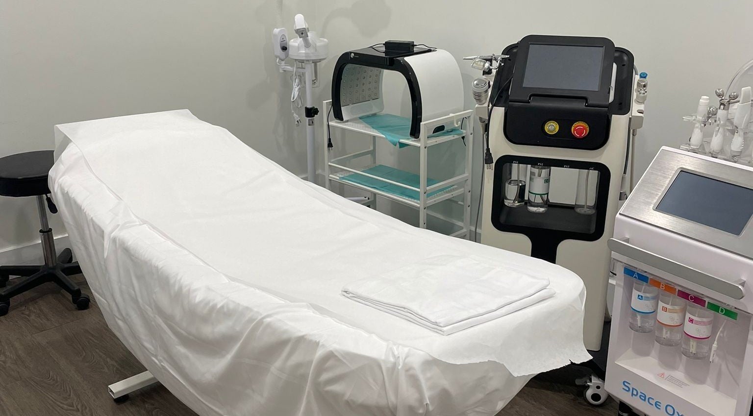 Relaxing treatment room at Anima Medspa, Toronto, Ontario, CA with advanced wellness equipment.