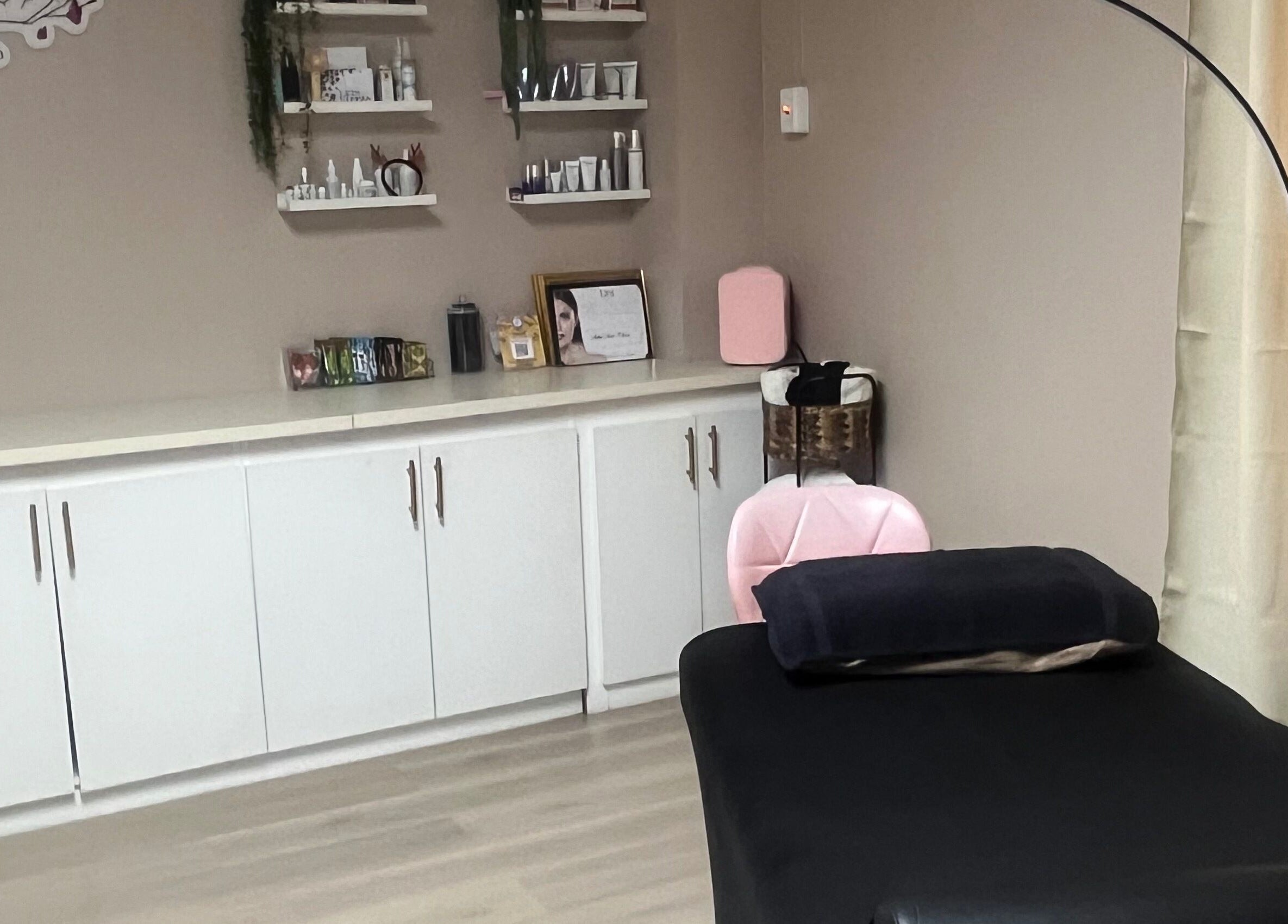 Elegant treatment room at SKYN BY SOPHIA AESTHETICS, Chaguanas, TT. Features sleek shelving and modern decor.