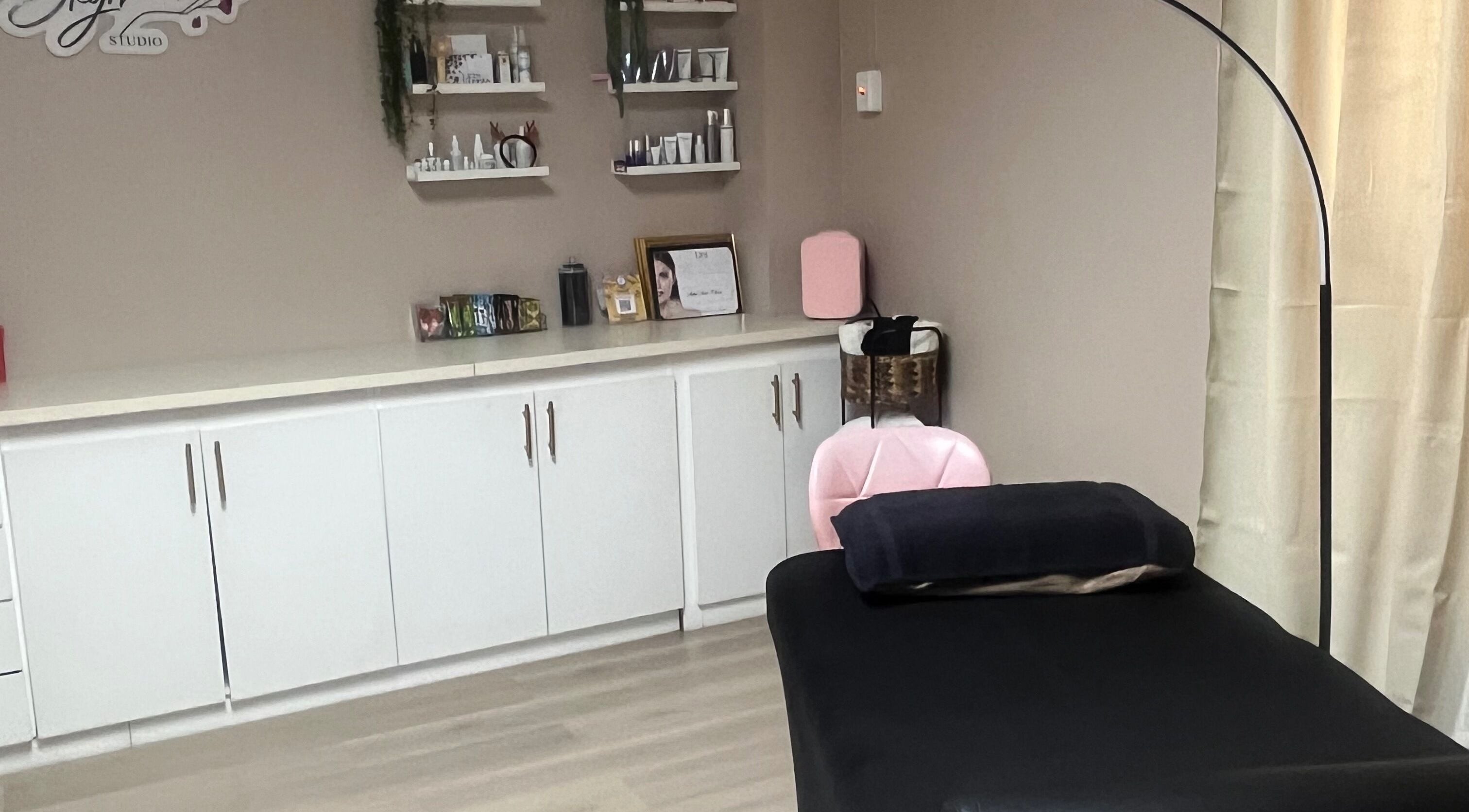 Elegant treatment room at SKYN BY SOPHIA AESTHETICS, Chaguanas, TT. Features sleek shelving and modern decor.