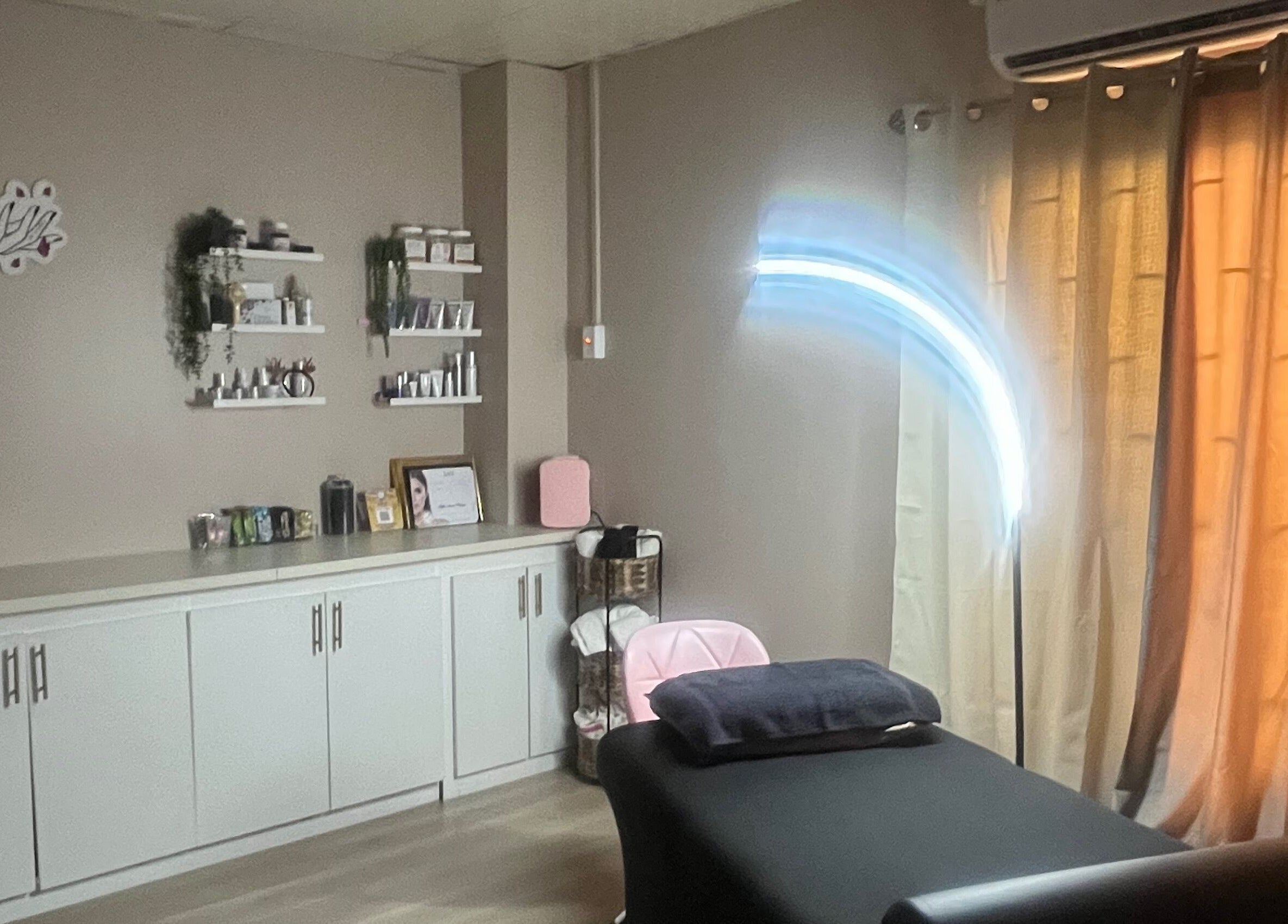 Tranquil treatment room at SKYN BY SOPHIA AESTHETICS in Chaguanas, TT, featuring a cozy massage table.