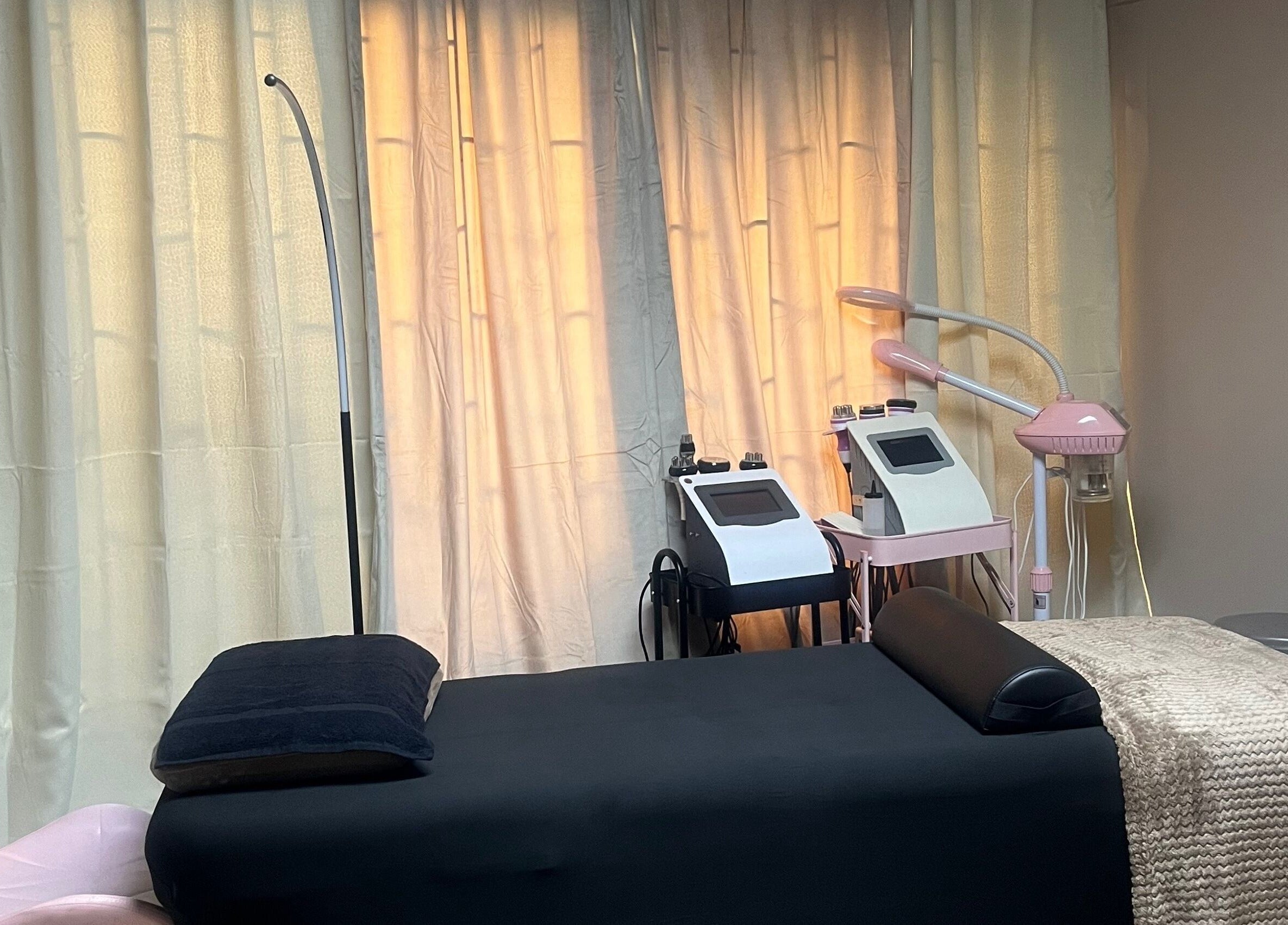 Spa treatment room at SKYN BY SOPHIA AESTHETICS, Chaguanas, TT with modern equipment and a relaxing bed.