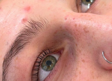 Close-up of a client's eye at Bliss Beauty by Chloe, Willenhall, England, showcasing clear skin and a nose piercing.