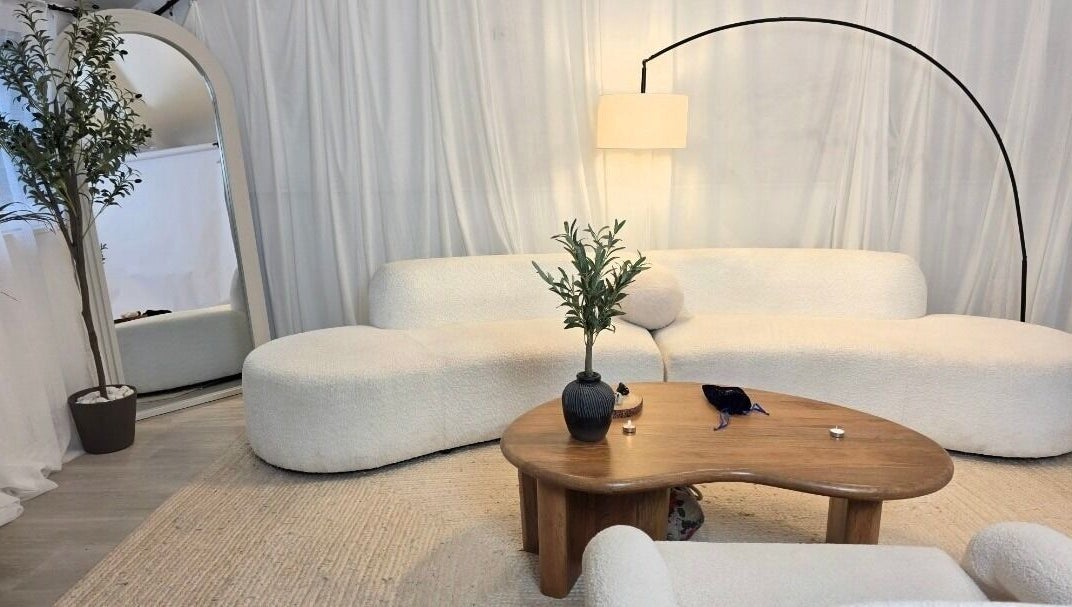 Cozy lounge at Jessica Vella-Templeton, Falmouth, England. Beige sofas, wood table, modern decor.