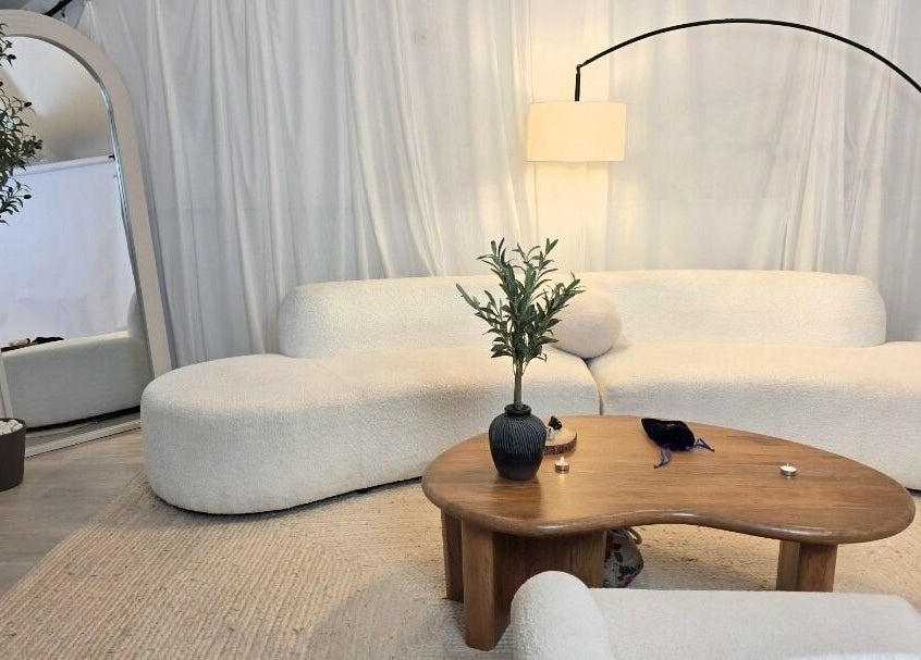 Cozy lounge at Jessica Vella-Templeton, Falmouth, England. Beige sofas, wood table, modern decor.