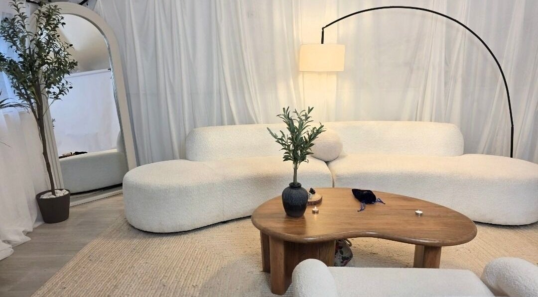 Cozy lounge at Jessica Vella-Templeton, Falmouth, England. Beige sofas, wood table, modern decor.