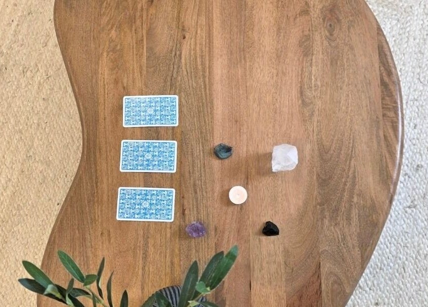 Tarot cards, crystals, and candle on table at Jessica Vella-Templeton, Falmouth, England, GB.