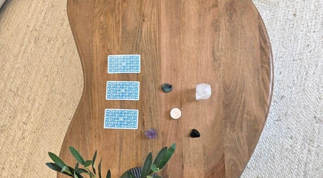 Tarot cards, crystals, and candle on table at Jessica Vella-Templeton, Falmouth, England, GB.