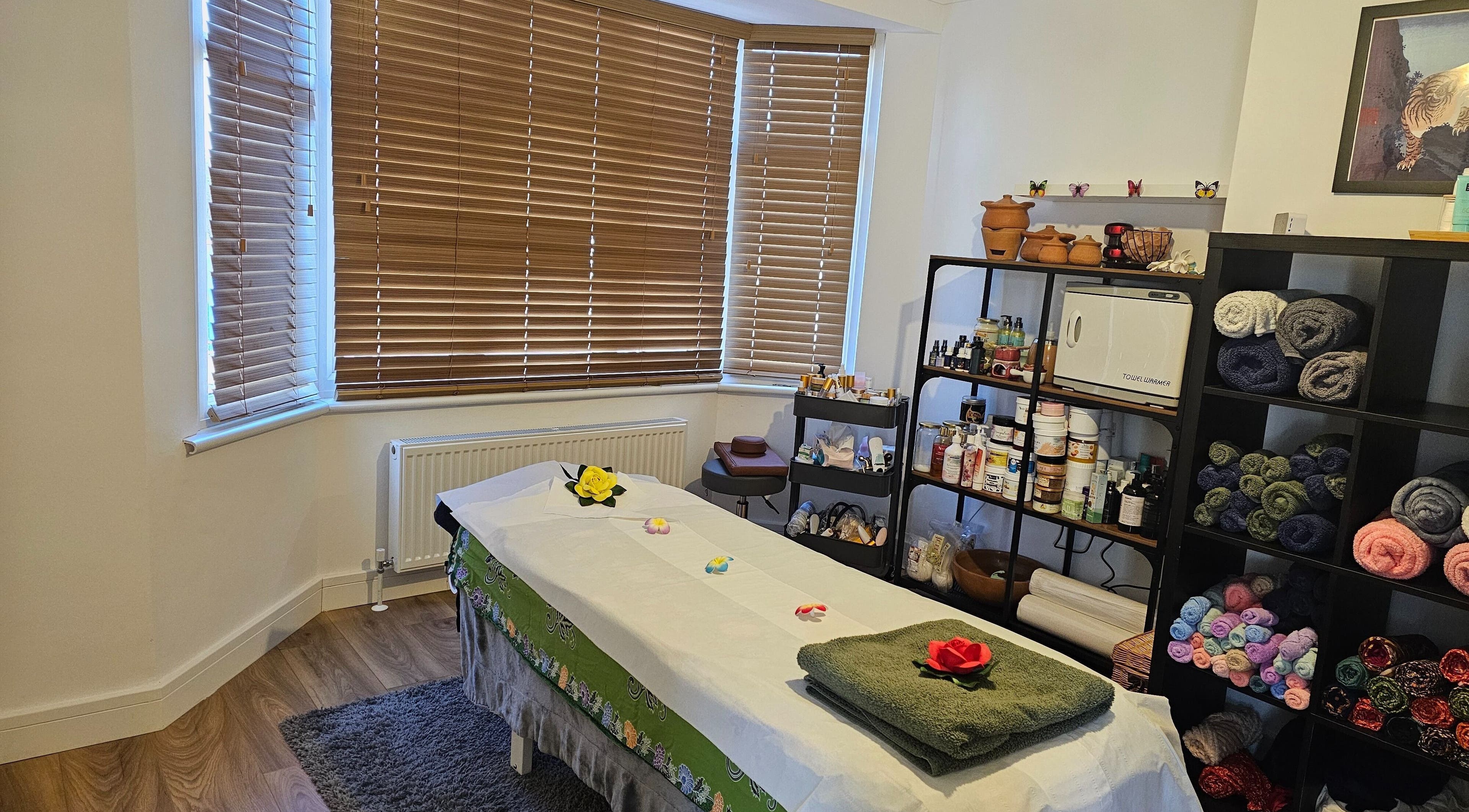 Calming massage room at Nattavadee Ann Thai Therapy Massage, Addlestone, England, GB, featuring a tranquil table setup.