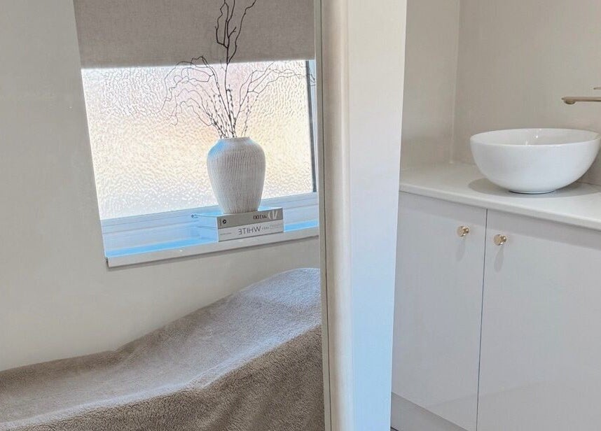 Relaxing treatment room at BySamantha, Stoke-on-Trent, England, GB with a cozy bed and elegant decor.