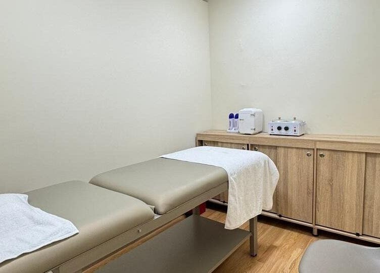 Sala de tratamiento en Nudeskinwaxing, Medellín, Antioquia, CO, con mesa de masaje y mobiliario moderno.