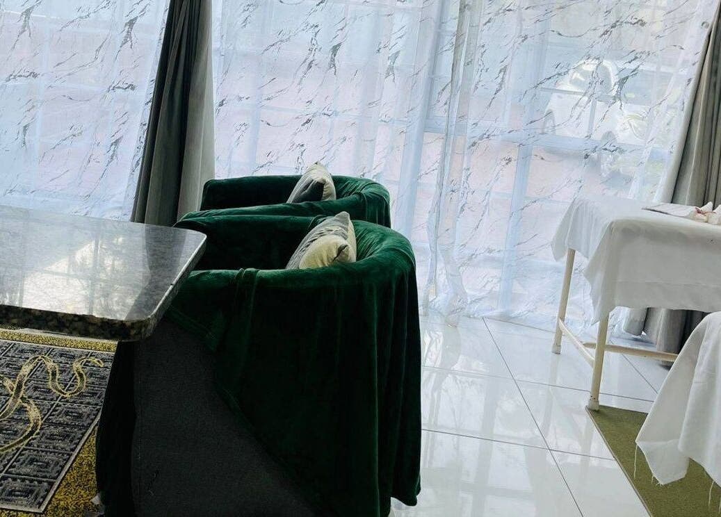 Elegant therapy lounge at Thai Touch Therapy, Durban, Kwazulu-natal, ZA featuring plush chairs and massage tables.