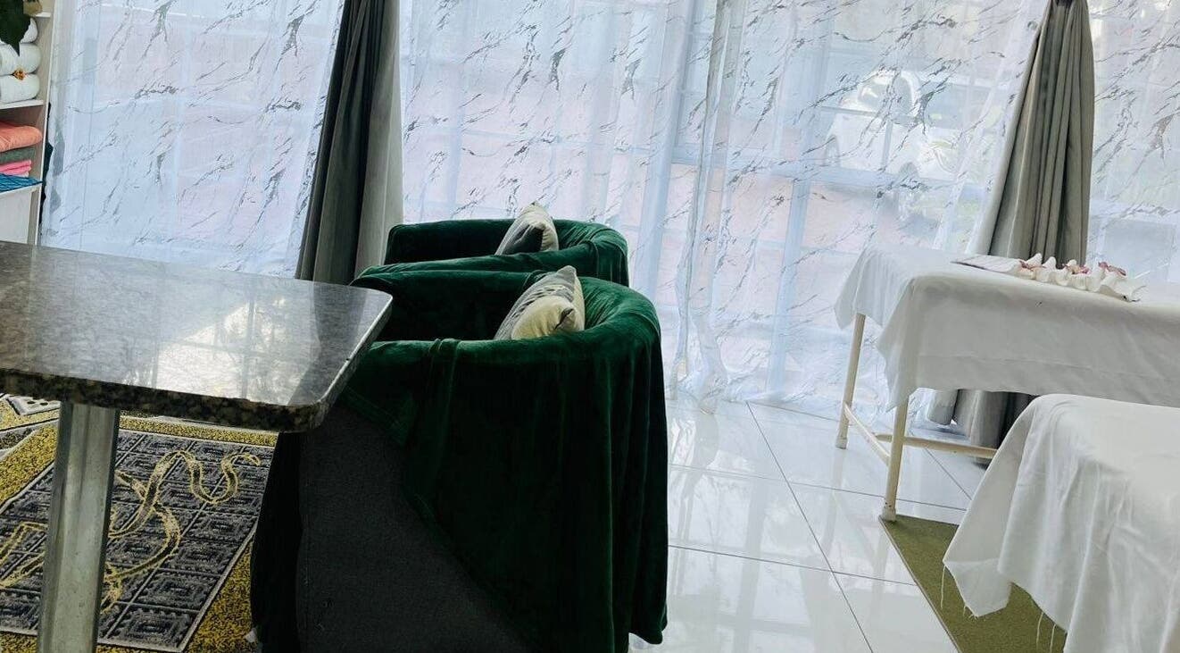 Elegant therapy lounge at Thai Touch Therapy, Durban, Kwazulu-natal, ZA featuring plush chairs and massage tables.