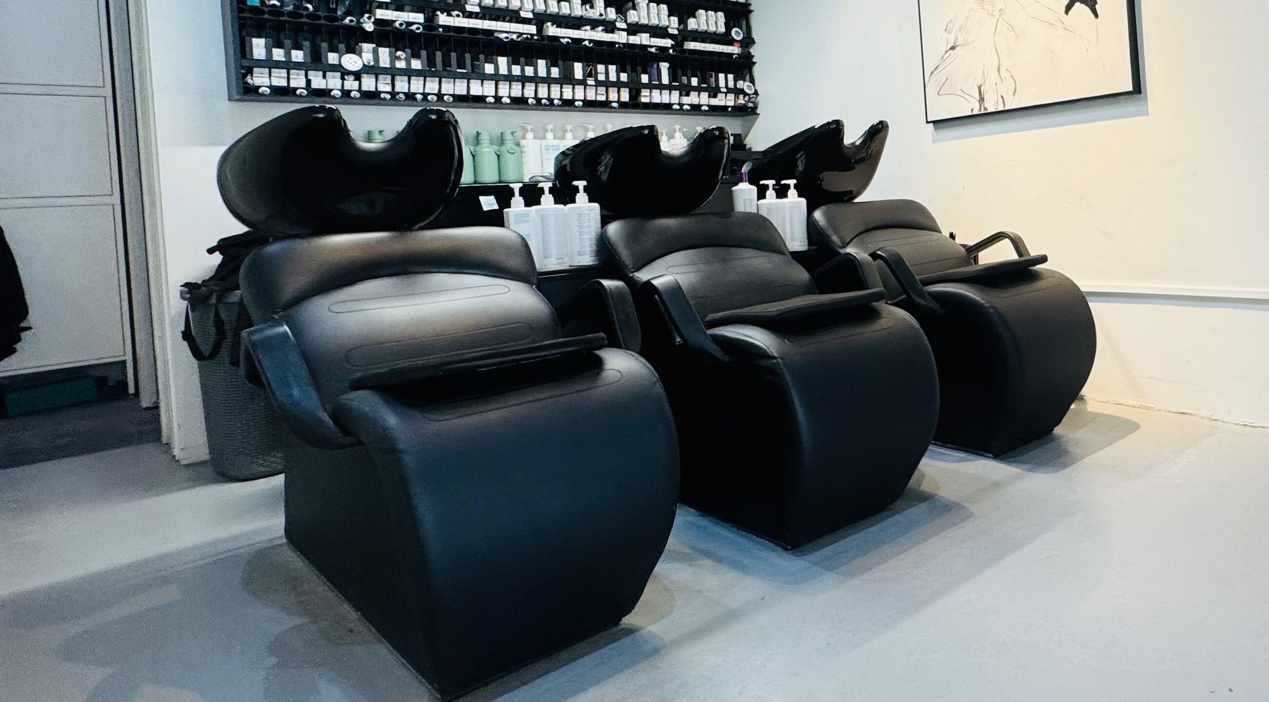 Modern salon wash stations at Hair by Sa, Surry Hills, New South Wales, AU, offering premium hair care.