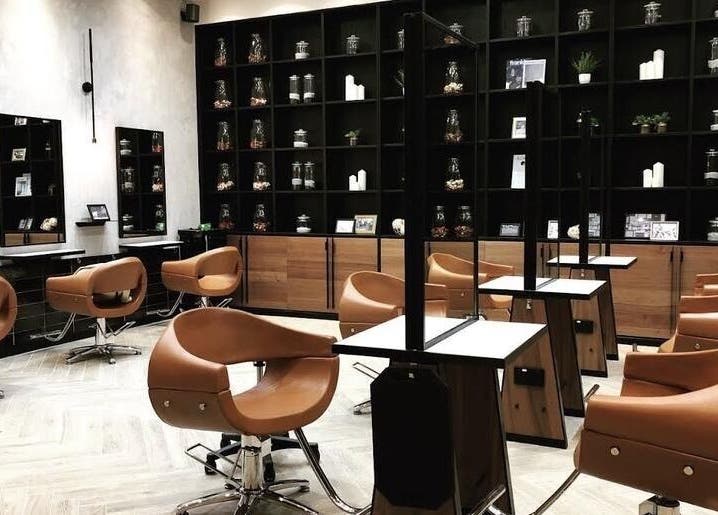 Modern salon interior at AUBE Marina Square, Singapore, SG, featuring sleek chairs and elegant decor.