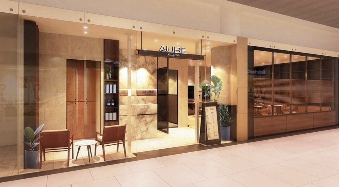 Entrance of AUBE Marina Square, a chic beauty venue in Singapore, SG with stylish decor and warm lighting.