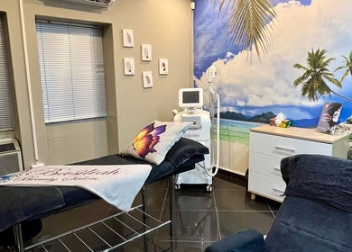 Relaxing treatment room at Basiliah Beauty Salon Tan Can in Pretoria, Gauteng, ZA with tropical beach mural.