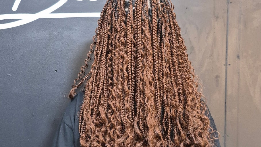 Intricate brown braids showcasing professional hairstyle at Melbee Hair & Beauty salon in Thembisa, Gauteng, ZA.