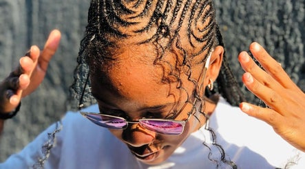 Intricate braided hairstyle at BRILLO BONITA EMPIRE, Windhoek, Khomas Region, NA, capturing sunlight.