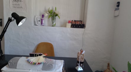 Elegant nail station at Twin Glam, Cape Town, Western Cape, ZA with organized polish and manicure tools.