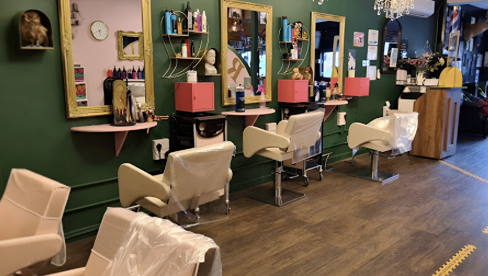 Chic interior of Beard and Blow Hairdressing Salon in Romford, England, GB with elegant styling chairs and mirrors.