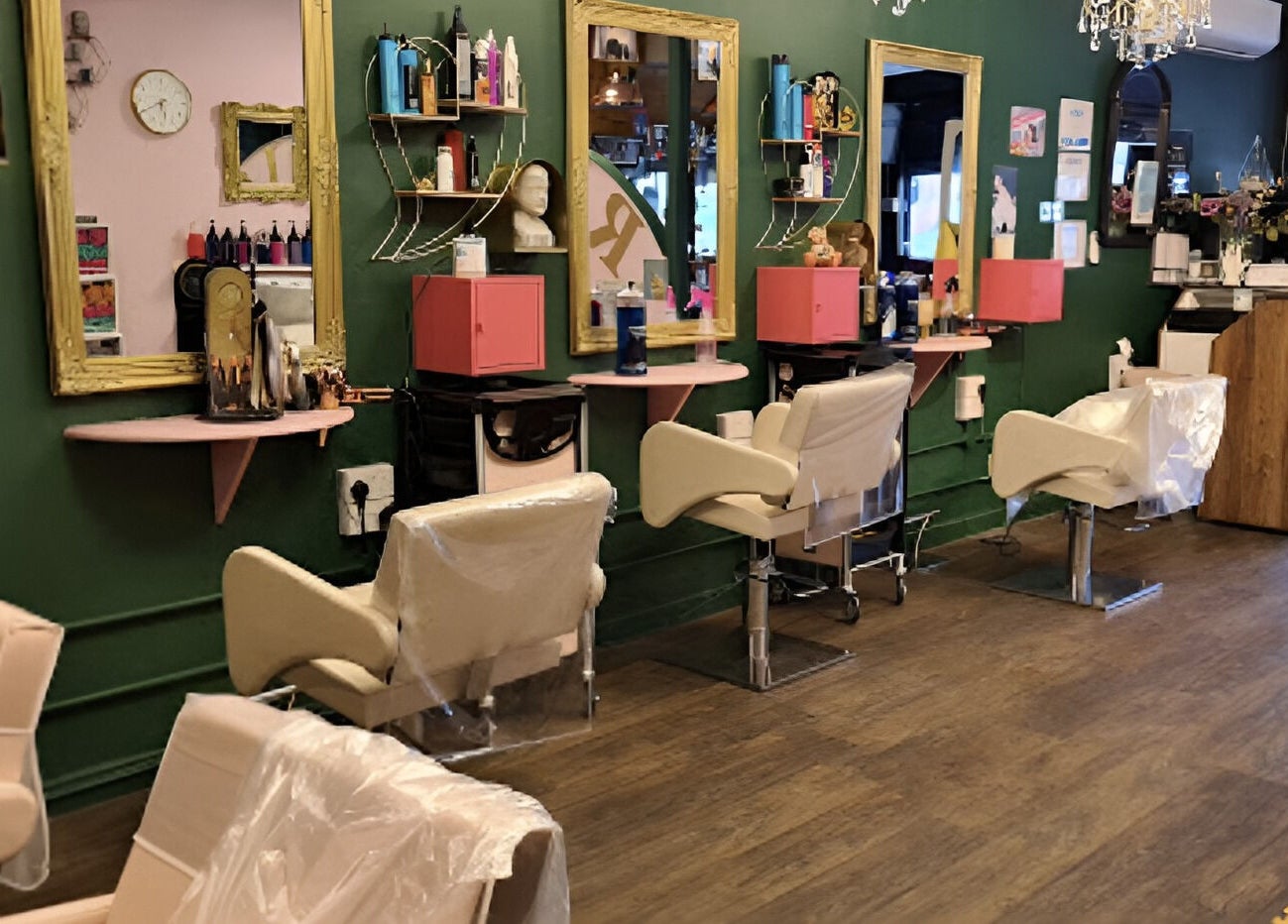 Chic interior of Beard and Blow Hairdressing Salon in Romford, England, GB with elegant styling chairs and mirrors.