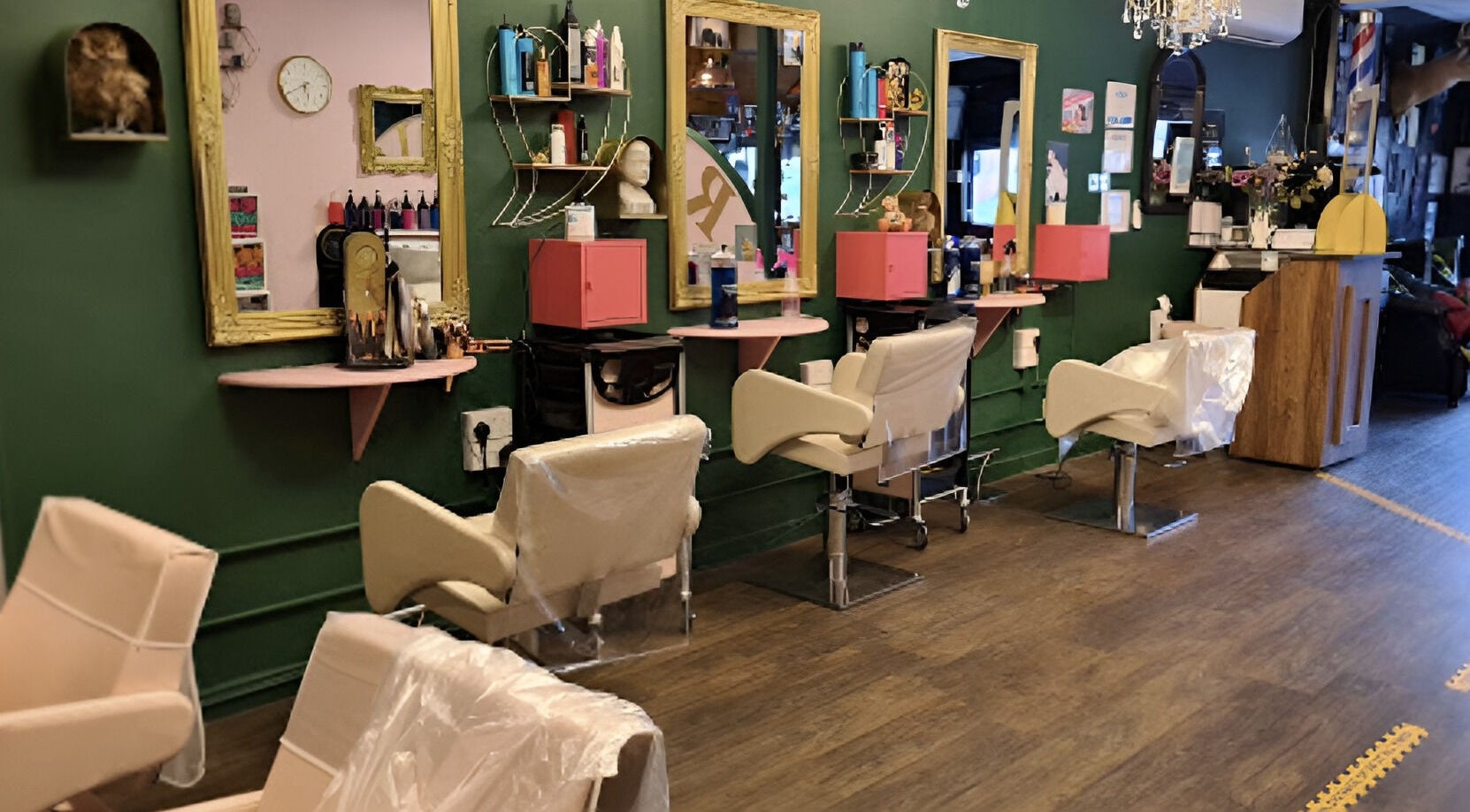 Chic interior of Beard and Blow Hairdressing Salon in Romford, England, GB with elegant styling chairs and mirrors.