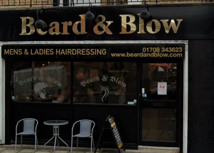 Exterior of Beard and Blow Hairdressing Salon in Romford, England, GB showcasing stylish signage.