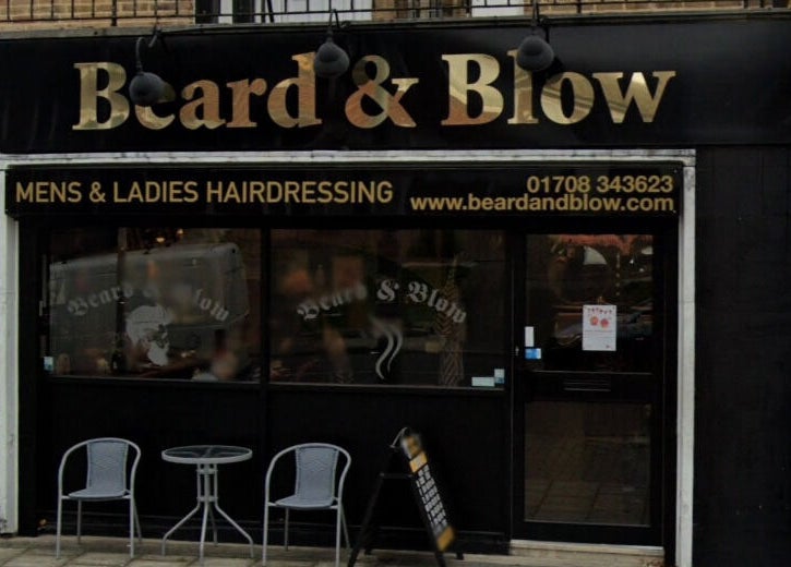 Exterior of Beard and Blow Hairdressing Salon in Romford, England, GB showcasing stylish signage.