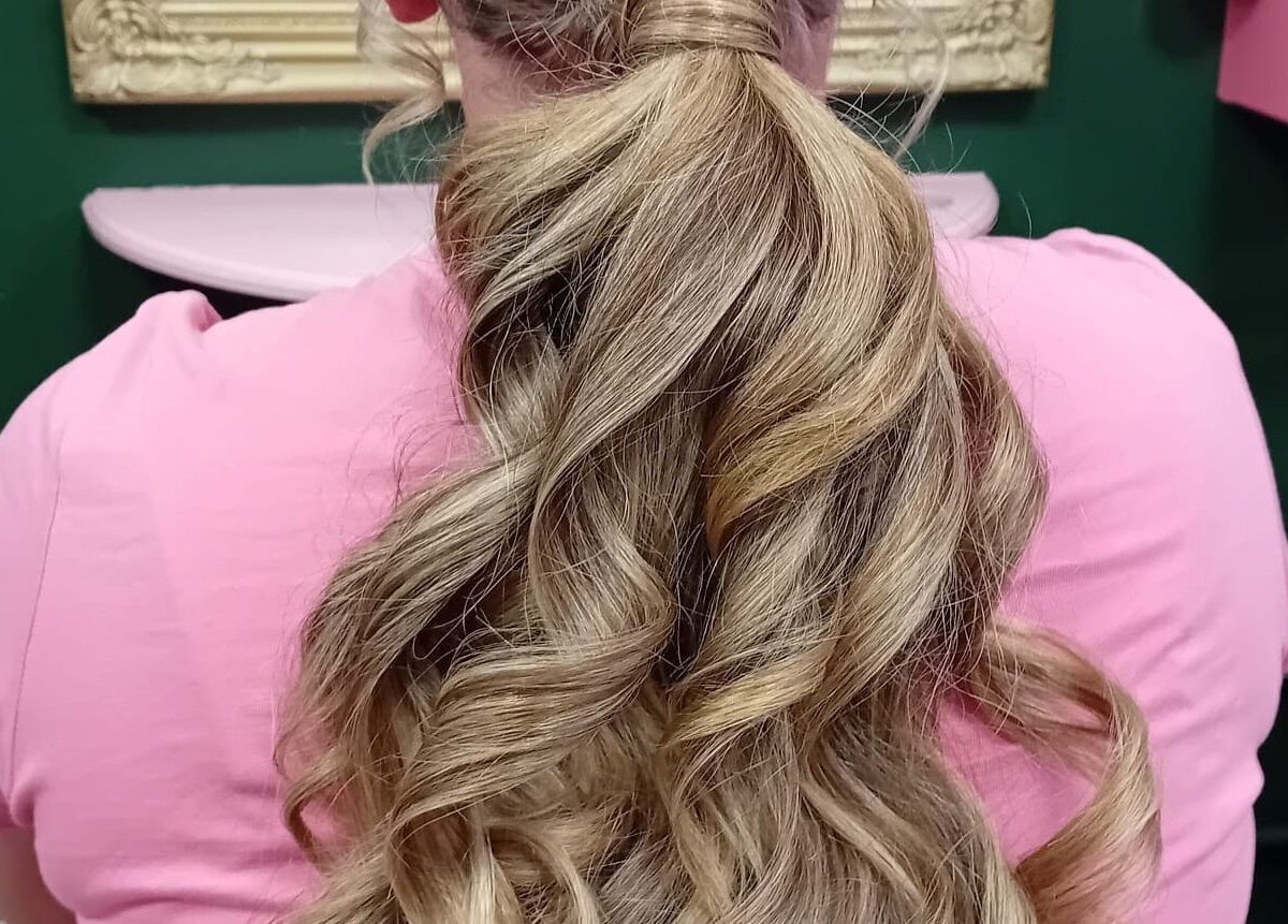 Elegant long ponytail hairstyle at Beard and Blow Hairdressing Salon in Romford, England, GB.