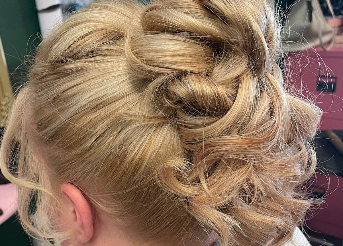 Elegant blonde updo hairstyle at Beard and Blow Hairdressing Salon, Romford, England, GB.