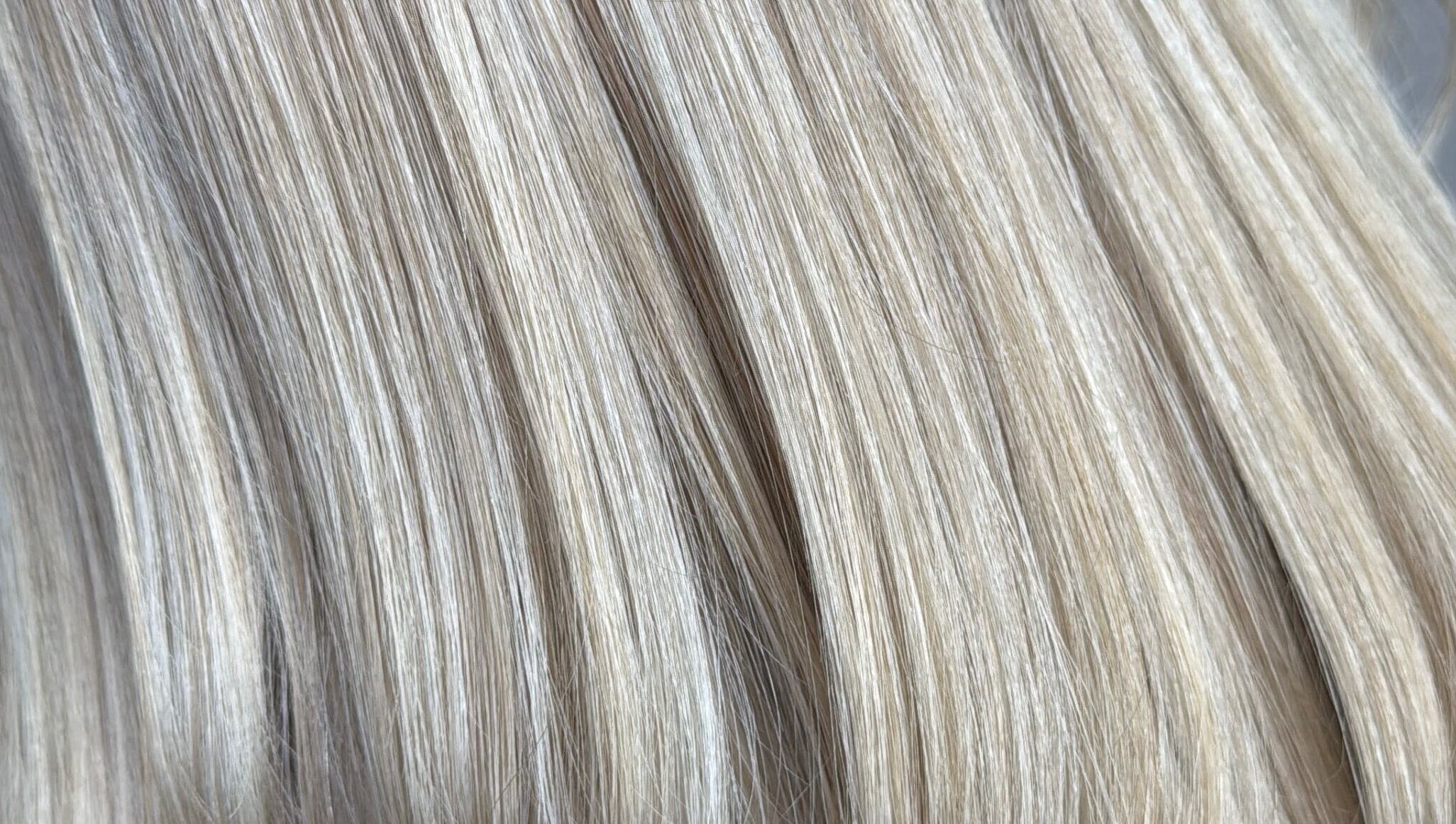 Close-up of sleek blonde hair at Emily V Hair, Coggeshall, England, GB showcasing expert hair styling.