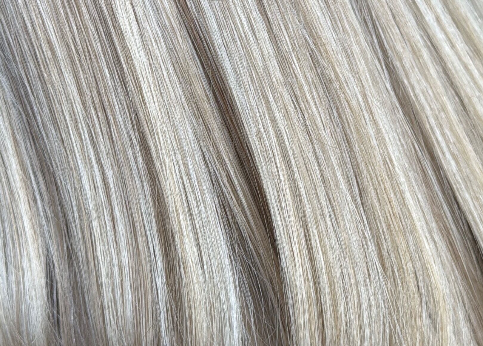 Close-up of sleek blonde hair at Emily V Hair, Coggeshall, England, GB showcasing expert hair styling.