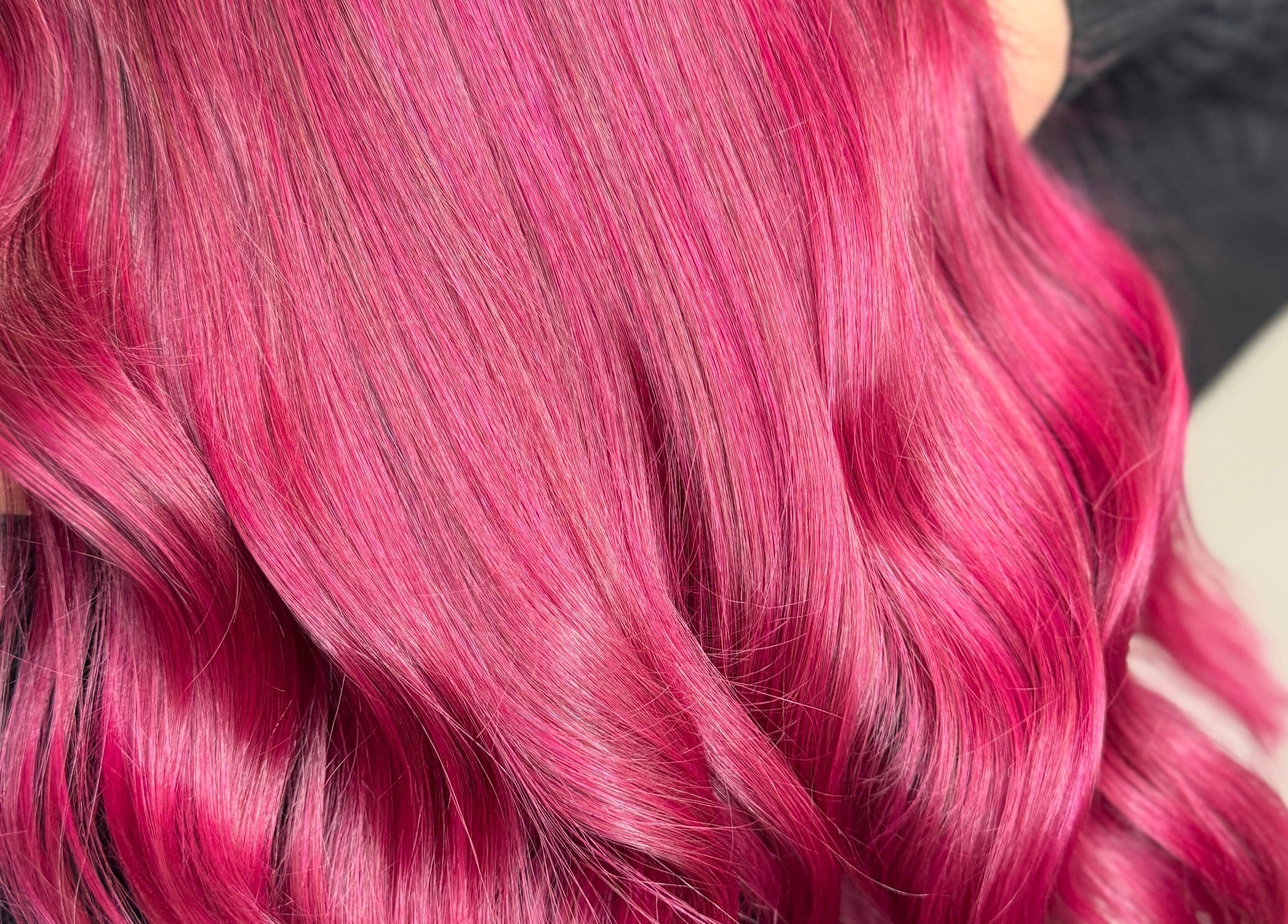 Vibrant pink hair styled at Emily V Hair, Coggeshall, England, GB, showcasing expert coloring techniques.