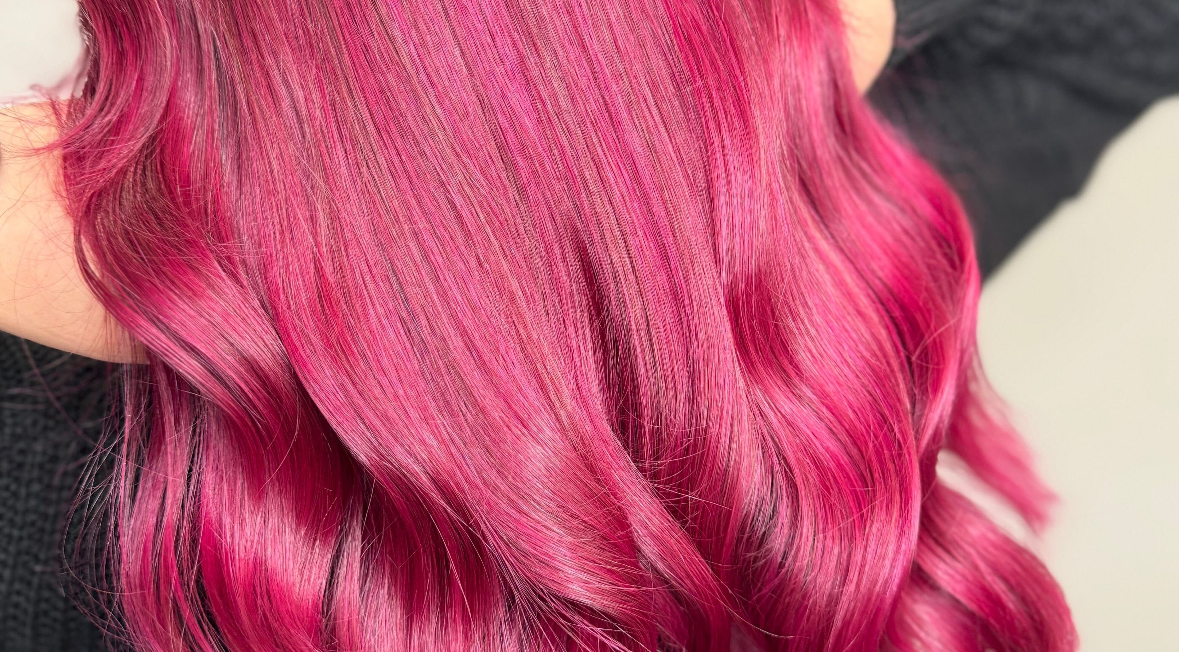 Vibrant pink hair styled at Emily V Hair, Coggeshall, England, GB, showcasing expert coloring techniques.