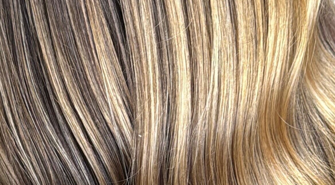 Golden blonde highlights at Emily V Hair in Coggeshall, England, GB enhance the natural hair texture.