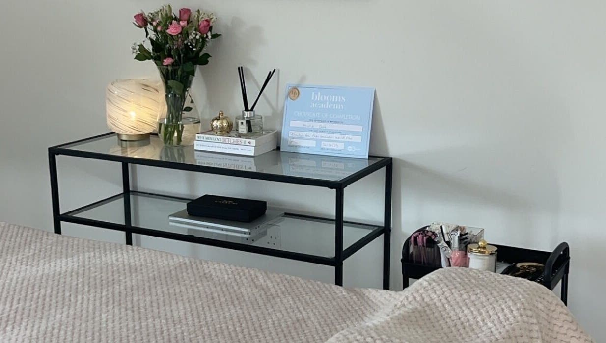 Peaceful setting at Rose Clark Beauty in Herne Bay, England, featuring a cozy table with flowers and soft lighting.